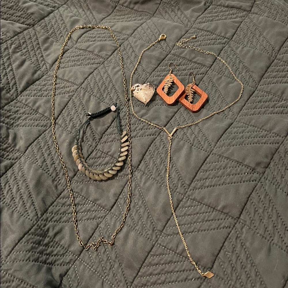 Natural elements assorted jewelry: Wood, gold, and jade.